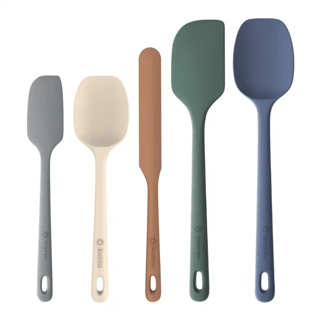 Silicone spatula gently folding cream into mascarpone mix